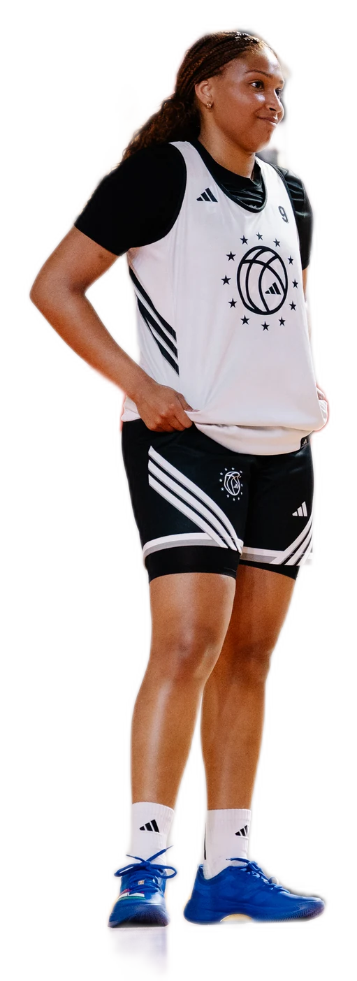 Amayah Garcia standing courtside in her black and white practice kit, hands on her hips.