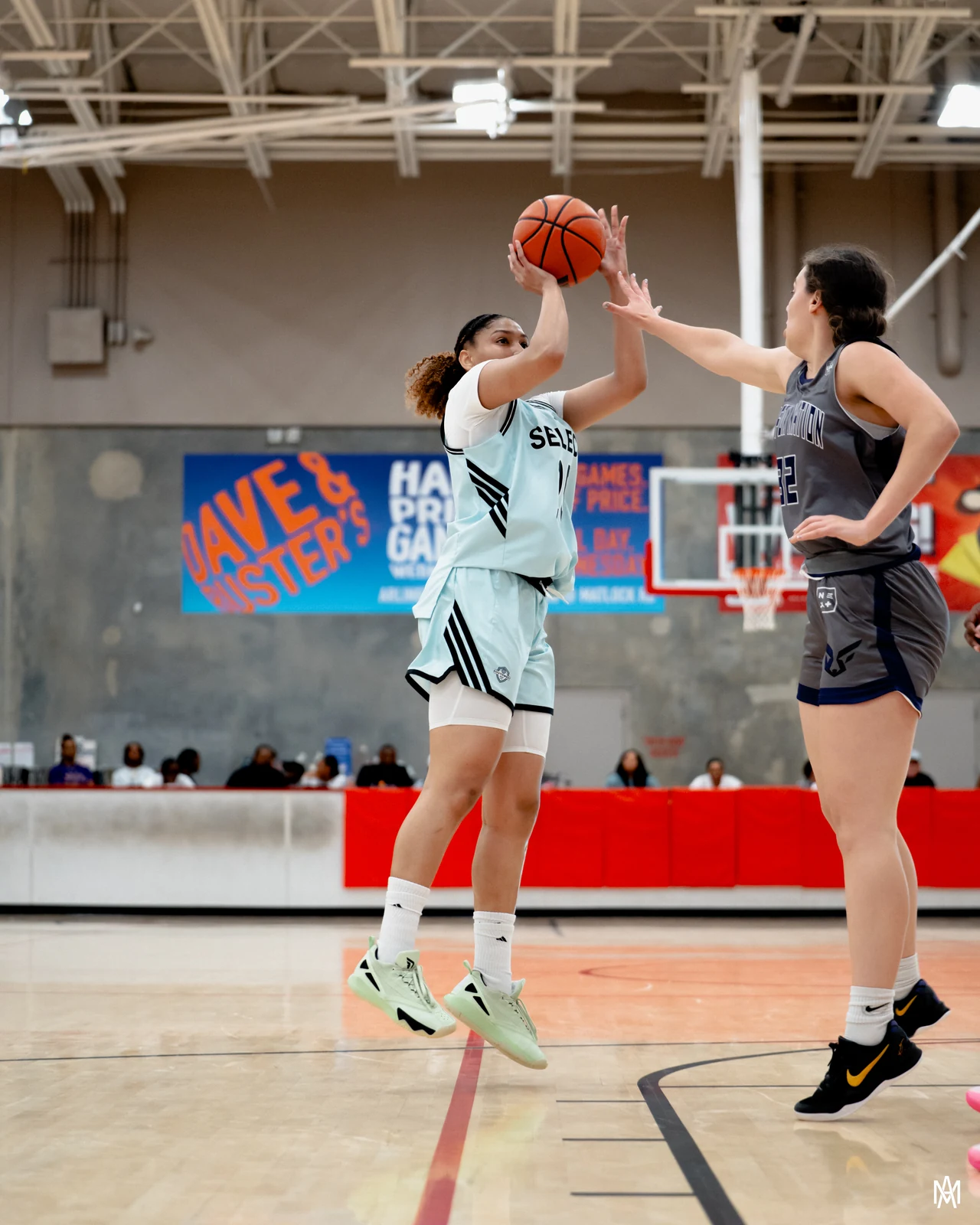 Amayah Garcia rising off both feet for a pull-up jumper with a defender closing out on her.