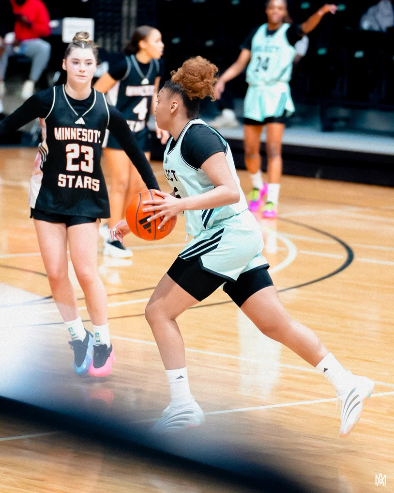 Amayah Garcia attacking downhill with the ball, driving past a defender in the open floor.