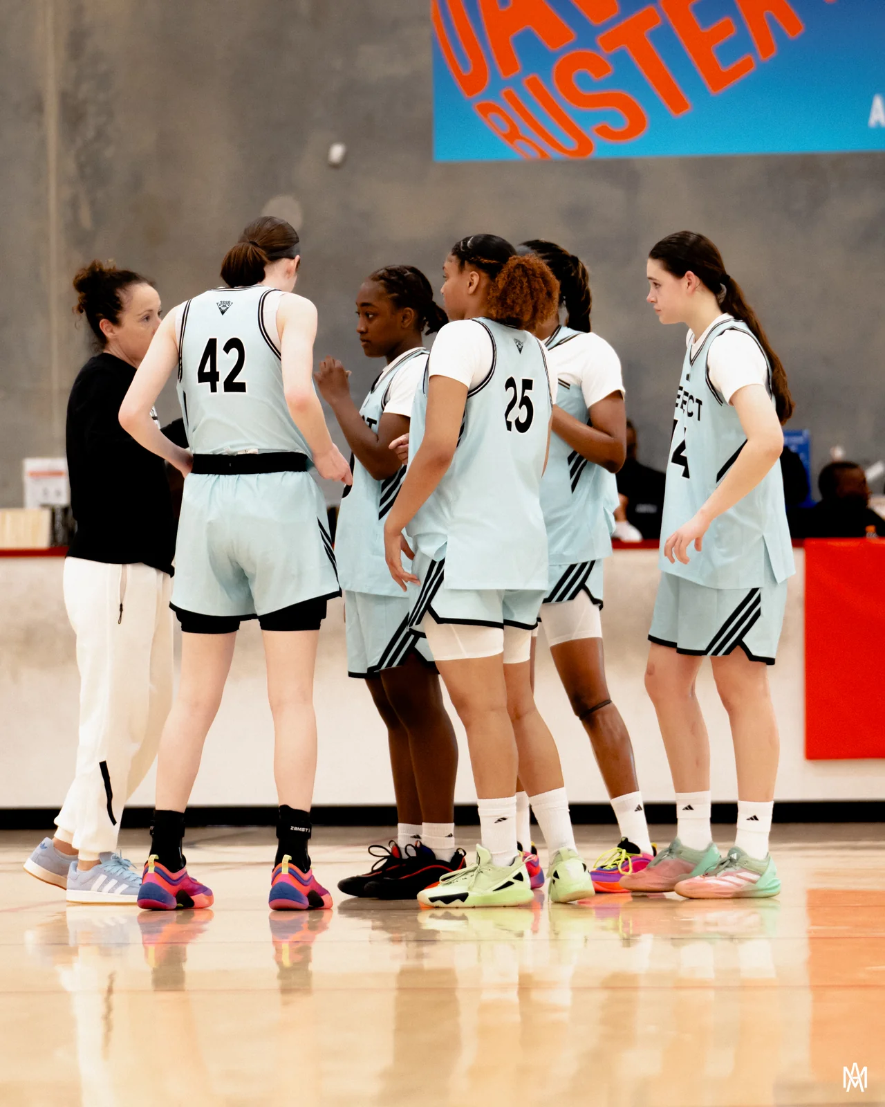 Amayah Garcia in the huddle with her Southwest Select teammates and coach during a break in play.